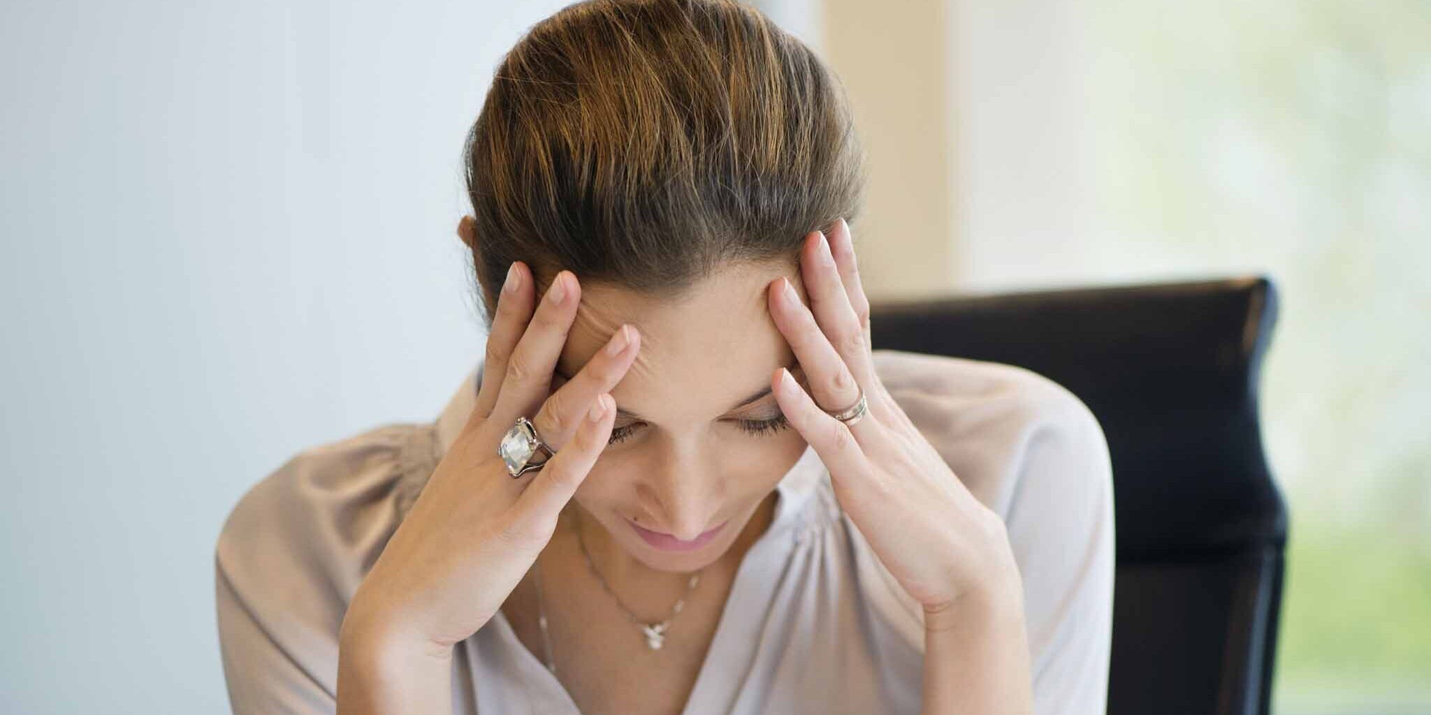 Close-up of a businesswoman suffering from a headache in an office